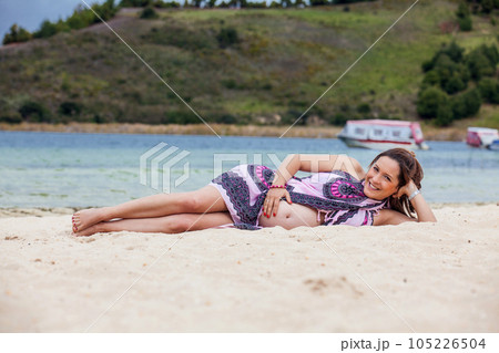 Portrait of a young woman waiting for her baby at the beautiful white beach of Lake Tota located in the department of Boyaca at 3,015 meters above sea level in Colombia 105226504