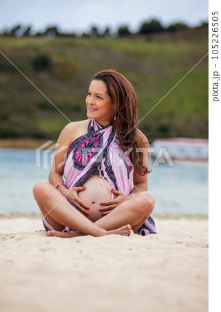 Portrait of a young woman waiting for her baby at the beautiful white beach of Lake Tota located in the department of Boyaca at 3,015 meters above sea level in Colombia 105226505