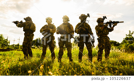 Smart teamwork of soldiers running forward and attacking enemy during military operation, Army soldiers in protective combat uniform, Soldiers with rifle, Soldiers with rifle on world war field 105226637
