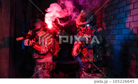 Expert team of soldiers attacking enemy during military operation, Army soldiers in protective combat uniform, Soldiers with rifle on world war field 105226645