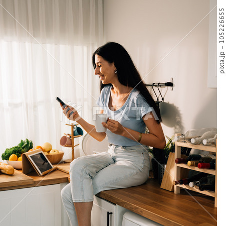 Happy young woman spending time at home, People relaxing and resting at modern house, People lifestyle, Beautiful woman sitting indoor at home 105226655