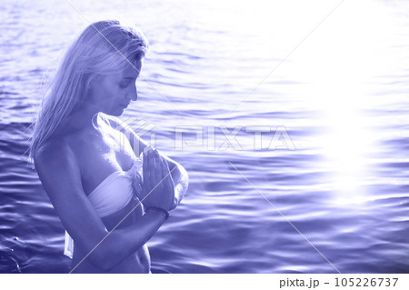 Beautiful young girl relaxing on a beach of tropical ocean Beautiful young girl relaxing on a beach of tropical ocean 105226737