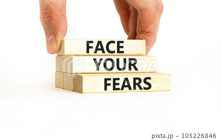 Face your fears and support symbol. Concept words Face your fears on wooden blocks. Businessman hand. Beautiful white table white background. Business and Face your fears quote concept. Copy space. Face your fears and support symbol. Concept words Face your fears on wooden blocks. Businessman hand. Beautiful white table white background. Business and Face your fears quote concept. Copy space. 105226846