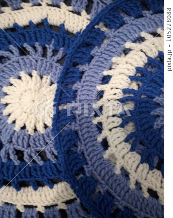 Blue, white round crochet elements and balls of yarn. Crochet texture, place for an inscription, adapted for mobile phone 105228088