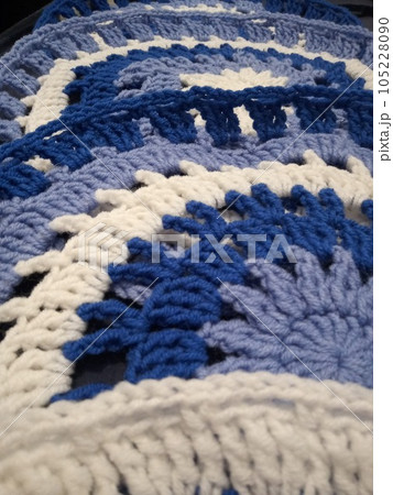 Blue, white round crochet elements and balls of yarn. Crochet texture, place for an inscription, adapted for mobile phone Blue, white round crochet elements and balls of yarn. Crochet texture, place for an inscription, adapted for mobile phone 105228090