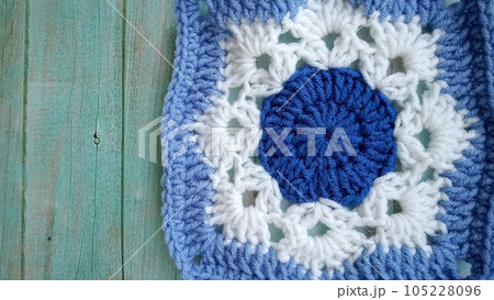 Blue, white crochet elements and orchid. Crochet texture, place for an inscription, adapted for mobile phone Blue, white crochet elements and orchid. Crochet texture, place for an inscription, adapted for mobile phone 105228096