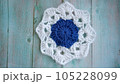 Blue, white crochet elements and orchid. Crochet texture, place for an inscription, adapted for mobile phone 105228099