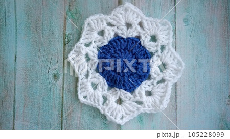 Blue, white crochet elements and orchid. Crochet texture, place for an inscription, adapted for mobile phone Blue, white crochet elements and orchid. Crochet texture, place for an inscription, adapted for mobile phone 105228099
