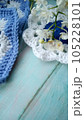 Blue, white crochet elements and orchid. Crochet texture, place for an inscription, adapted for mobile phone 105228101