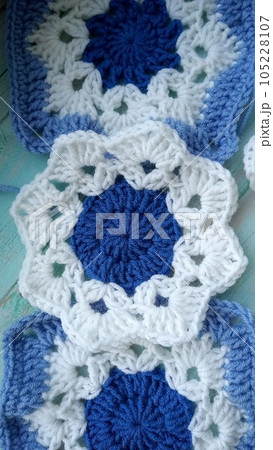 Blue, white crochet elements and orchid. Crochet texture, place for an inscription, adapted for mobile phone 105228107