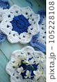 Blue, white crochet elements and orchid. Crochet texture, place for an inscription, adapted for mobile phone 105228108