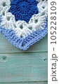 Blue, white crochet elements and orchid. Crochet texture, place for an inscription, adapted for mobile phone 105228109