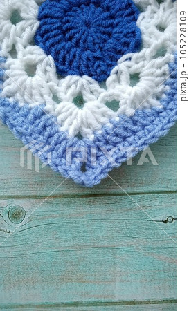 Blue, white crochet elements and orchid. Crochet texture, place for an inscription, adapted for mobile phone 105228109