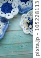 Blue, white crochet elements and orchid. Crochet texture, place for an inscription, adapted for mobile phone 105228113