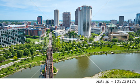 Train bridge leading into downtown of Columbus Ohio past American Electric Power skyscraper aerial 105229178
