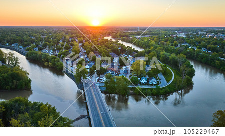 Bridge over horseshoe riverbend with houses small town cityscape landscape aerial sunrise sunset Bridge over horseshoe riverbend with houses small town cityscape landscape aerial sunrise sunset 105229467