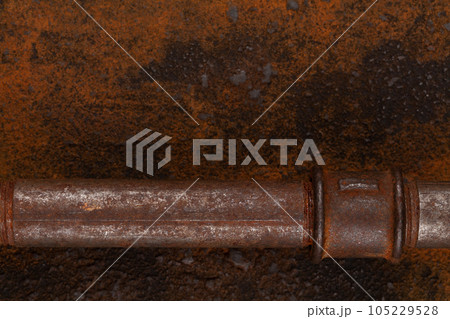 Rusty valve pipes on rusty metal wall Rusty valve pipes on rusty metal wall 105229528