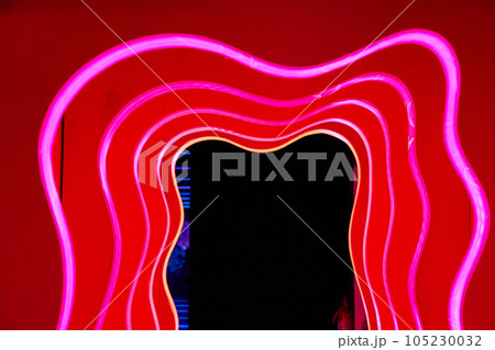 Red hallway of abstract red doors outlined in red neon lights and a black exit Red hallway of abstract red doors outlined in red neon lights and a black exit 105230032