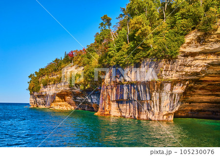 Turquoise green waters with soaring cliffs of pictured rocks national park 105230076