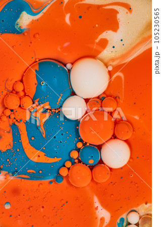 Vertical of egg-like bubbles in abstract sea of colors with oil and acrylic paint in background asset 105230565