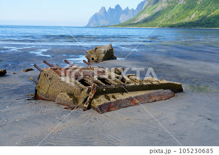 Remains of a sunken ship. wrecked cargo ship in Norway fjord. The weather is clear. 105230685