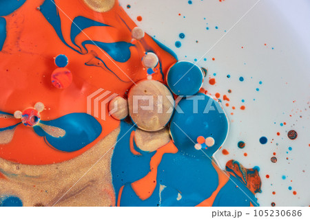 Vertical abstract painting asset with white background and flecks of blue gold and orange acrylic paint with oil bubbles in a cluster Vertical abstract painting asset with white background and flecks of blue gold and orange acrylic paint with oil bubbles in a cluster 105230686