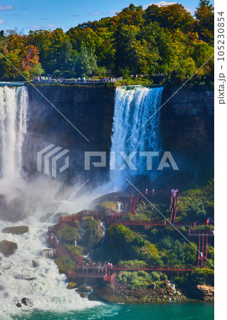 Niagara Falls vertical detail of tourists getting covered in mist by American Falls Niagara Falls vertical detail of tourists getting covered in mist by American Falls 105230854