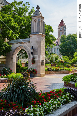 Sample Gates entrance with flowers and clock tower in Bloomington Indiana University 105230900