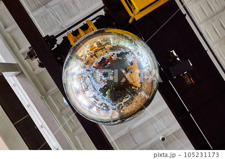 Reflective large disco ball on ceiling of old building Reflective large disco ball on ceiling of old building 105231173