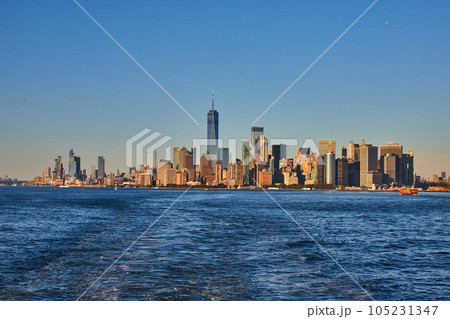 Stunning southern Manhattan island from ferry with soft golden light Stunning southern Manhattan island from ferry with soft golden light 105231347