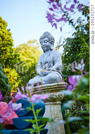 Shrine to Buddha with small statue in gardens Shrine to Buddha with small statue in gardens 105231717