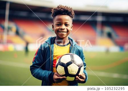 Afro-american boy holding football ball with his hands 105232295