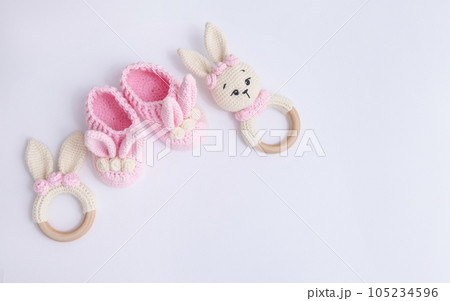 Cute wooden baby toys on a white background. Eco accessories and teethers for newborns. Blank space for text. Flat plan, top view. High quality photo 105234596