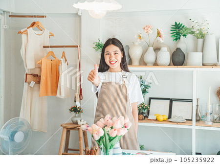 Small business owners pose smiling in their small shop to welcome customers and get customers online. And check the orders that customers have ordered of online retailers - online shopping. Small business owners pose smiling in their small shop to welcome customers and get customers online. And check the orders that customers have ordered of online retailers - online shopping. 105235922