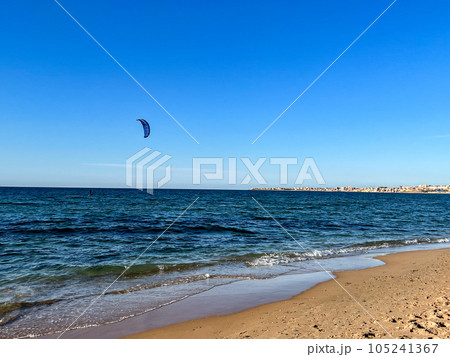 Kite surfer rides on the water in Staoueli, Algeria. High quality photo. Blue sky 105241367