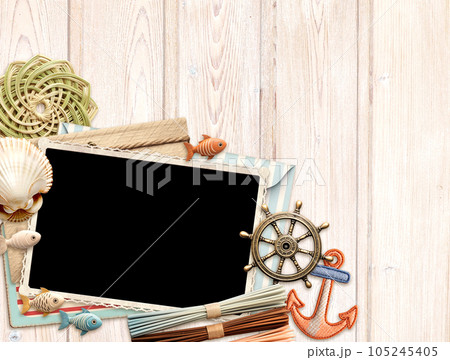 Vintage travel background with retro photo and envelope, postcard, small wooden fish and shell on old wood plank. Horizontal vacation backdrop. Copy space for text 105245405