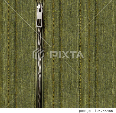 Dark green denim background with zipper. Khaki color denim jeans fabric texture and zip. Copy space for text 105245460
