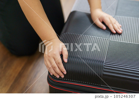 Woman preparing luggage packing in suitcase trolley luggage traveling alone solo girl. Woman preparing luggage packing in suitcase trolley luggage traveling alone solo girl. 105246307