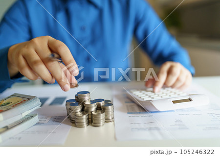 Business woman calculating financial statement on calculator income tax online return and payment. Business woman calculating financial statement on calculator income tax online return and payment. 105246322