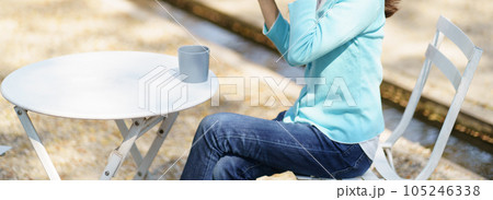 Woman hands holding cup of coffee in the park 105246338