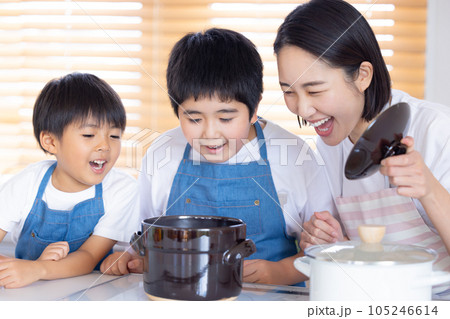 土鍋の蓋を開けて炊き立てご飯を見る家族 土鍋の蓋を開けて炊き立てご飯を見る家族 105246614