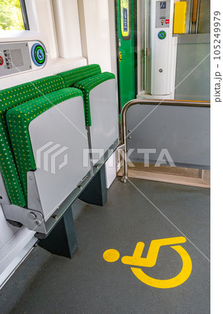 Special place for wheelchaired people in the local German train with the floor sign 105249979