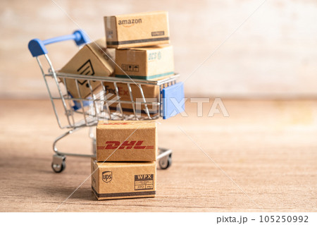 Bangkok, Thailand September 26, 2022 Shopping cart with DHL Amazon and FedEx express packing box, import export online exchange investment business. Bangkok, Thailand September 26, 2022 Shopping cart with DHL Amazon and FedEx express packing box, import export online exchange investment business. 105250992