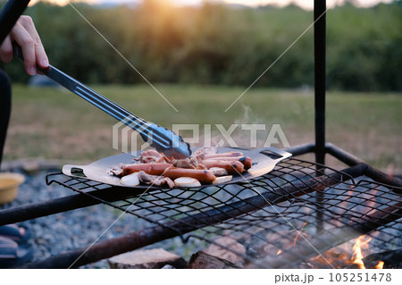 Man cooking on the fire at campsite. Tourism recreation outside, camping and travel concept 105251478