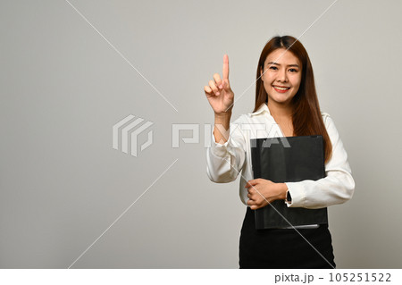 Beautiful asian woman office worker finger empty space isolated on gray background 105251522
