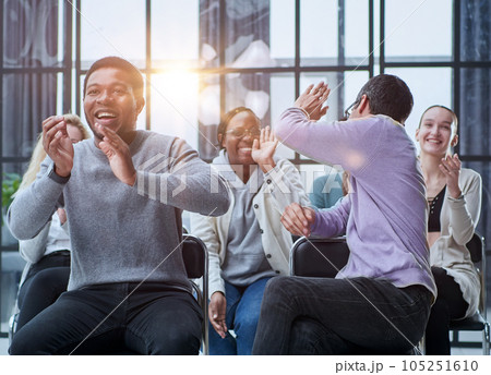 close up. young people sitting in a row applaud 105251610