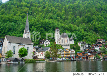 A Beautiful Lakeside View with Stunning Mountain Scenery and Historic Buildings. 105253734