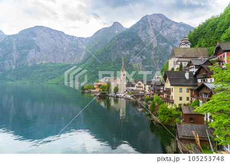 A Beautiful Lakeside View with Stunning Mountain Scenery and Historic Buildings. 105253748