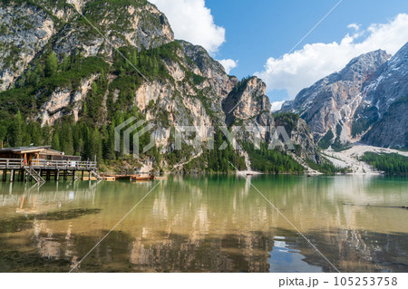 The lake is clear, sometimes green, sometimes blue, and surrounded by mountains. The lake is clear, sometimes green, sometimes blue, and surrounded by mountains. 105253758