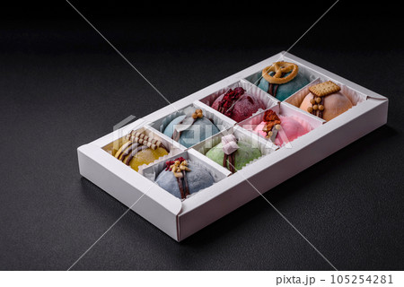 Delicious sweet colorful mochi desserts or ice cream with rice dough and toppings Delicious sweet colorful mochi desserts or ice cream with rice dough and toppings 105254281